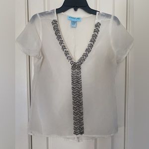 Beautiful sheer top with beading detail. Dress it up or down